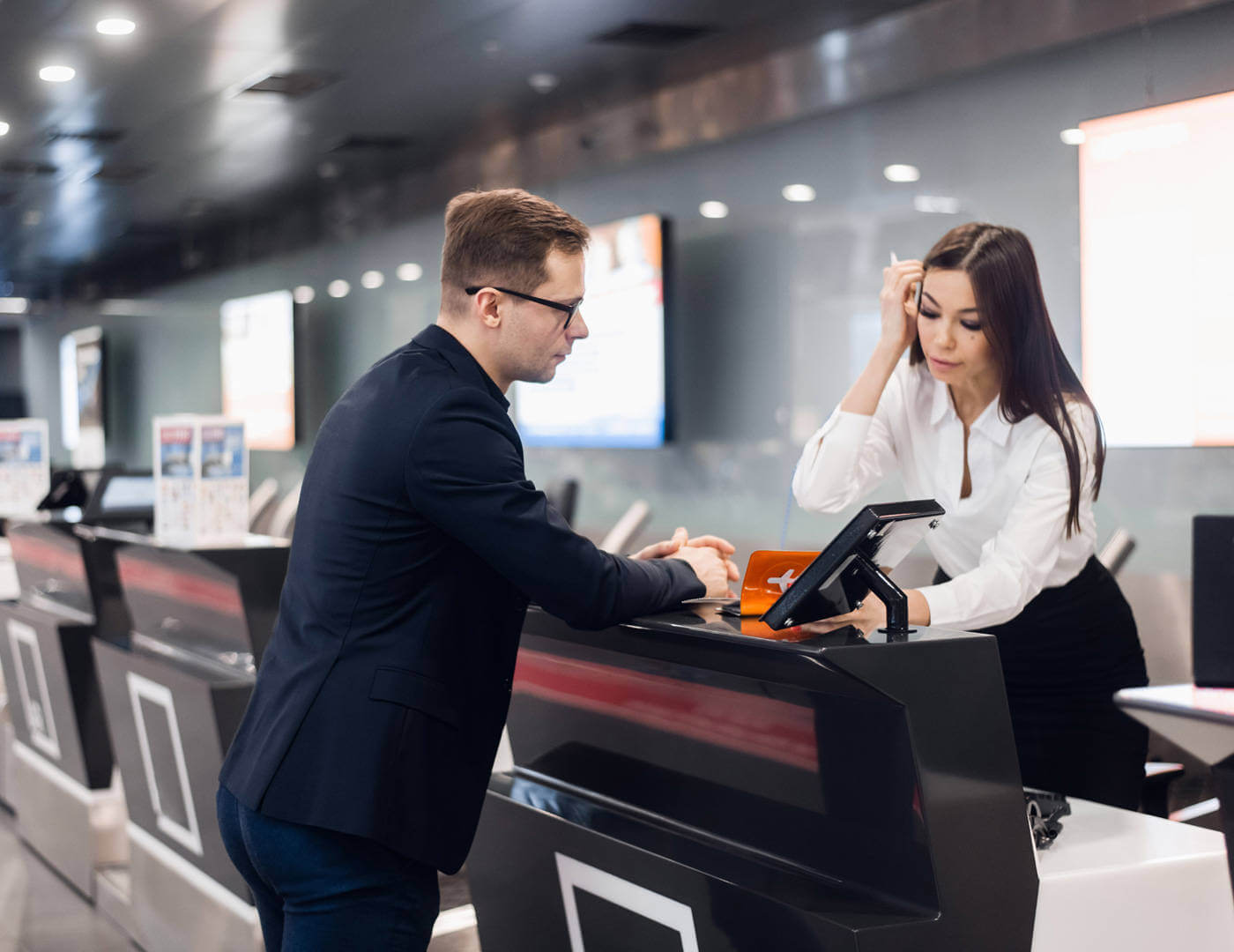 Airport Technology to Integrate anything, Innovate everything. The image shows a passenger being helped at a check in desk.