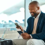 Airport data is key to a great passenger experience in airports. This image depicts a man accessing flight information on his smartphone.