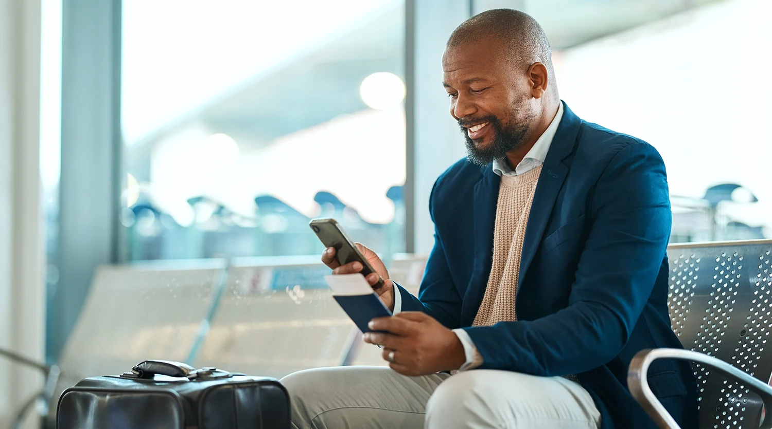 Airport data is key to a great passenger experience in airports. This image depicts a man accessing flight information on his smartphone.